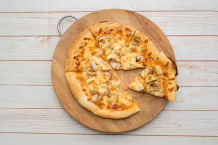 Hawaiian Tuna pizza on the wooden chopping board.View from top.の写真素材