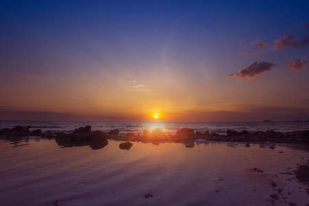 Amazing sunset view at the beach with reflection.の写真素材