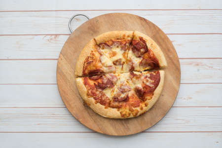Pepperoni pizza on the wooden chopping board.View from top.の写真素材