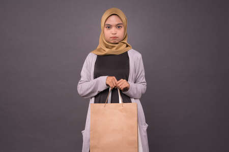 Happy malay girl holding shopping bags.の写真素材