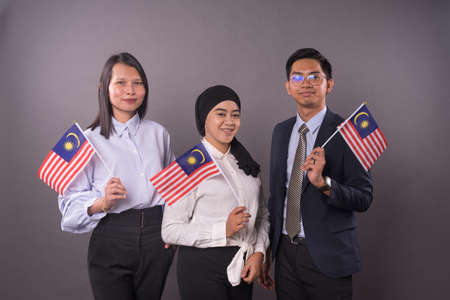 Group of peoples holding Malaysia Flag.Independence day and patriotic concept.の写真素材
