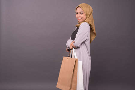 Happy malay girl holding shopping bags.の写真素材