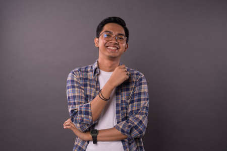Asian teenager with casual outfit and smiling face reaction..Studio shot.の写真素材
