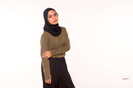 Casual Hijab Fashion.Cute Muslim girl with casual dress and hijab isolated over white background.の写真素材