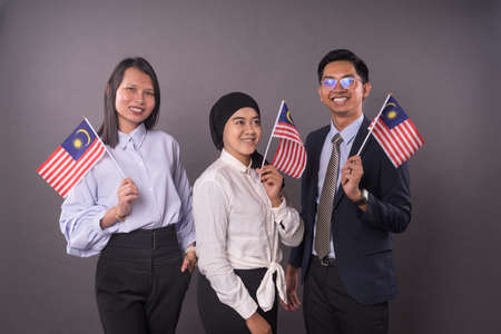 Group of peoples holding Malaysia Flag.Independence day and patriotic concept.の写真素材