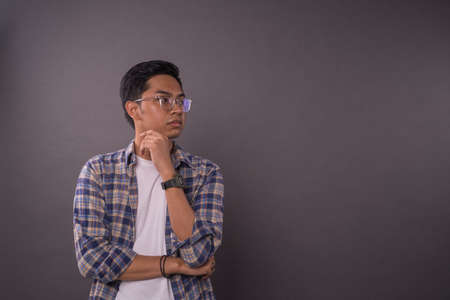 Asian boy or student with serious face reaction looking to right side.Copy space.の写真素材