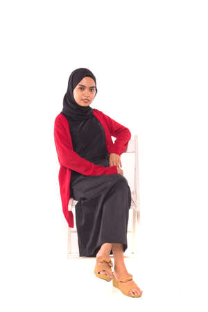 Casual Hijab Fashion.Cute Muslim girl with casual dress and hijab isolated over white background.の写真素材