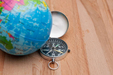 Travel concept.World Globe and compass on the wooden table.の写真素材