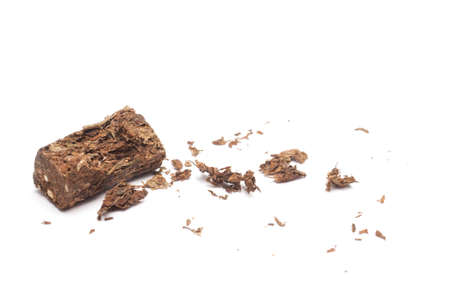 Compacted dried marijuana isolated over white background.