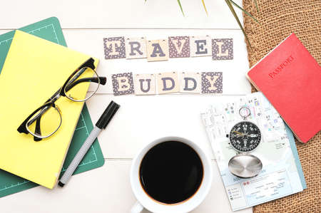 Travel Tips concept.A compass ,book, passport and coffee cup on white desk written wioth text "Travel Tips"の写真素材