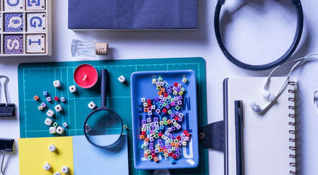 Notebook, magnifying glass and few other stationery objects on white table.View from top.Education concept.の写真素材