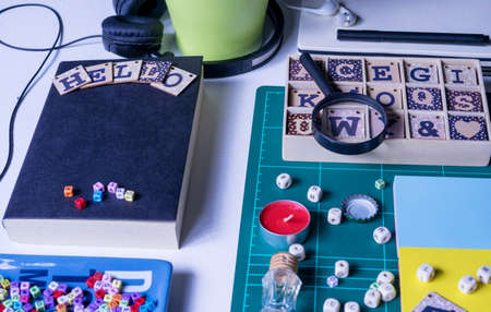 Notebook, magnifying glass and few other stationery objects on white table.View from top.Education concept.の写真素材