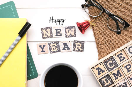 Wooden alphabet block forming word Happy New Year on white office desk.の写真素材