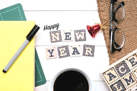 Wooden alphabet block forming word Happy New Year on white office desk.の写真素材