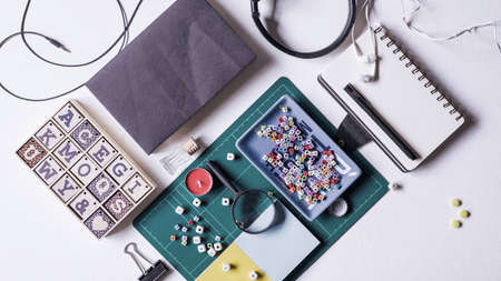 Notebook, magnifying glass and few other stationery objects on white table.View from top.Education concept.の写真素材