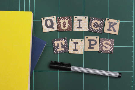 Chalk board and analog alarm clock with text Quick Tips written on the board.