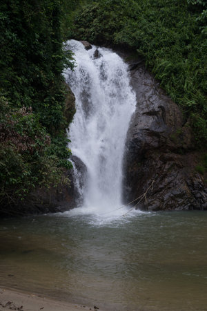 Beautiful view of rainforest waterfall in slow shutter mode.Soft focus due to slow shutter and high ISO shot.の写真素材