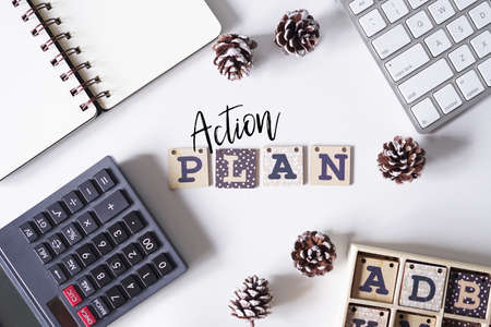 Computer keyboard,pinecones and notebook written with text BUSINESS PLAN on white office table.の写真素材