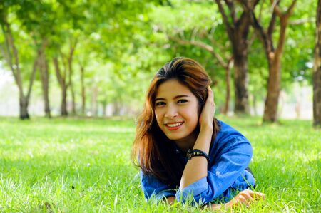 beautiful young woman in a spring park.の写真素材