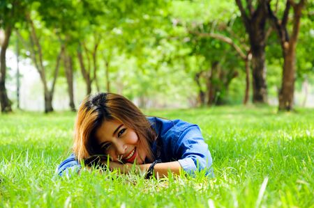 beautiful young woman in a spring park.の写真素材