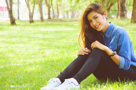 beautiful young woman in a spring park.の写真素材