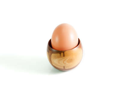 eggs in cup wood on white backgroundの写真素材