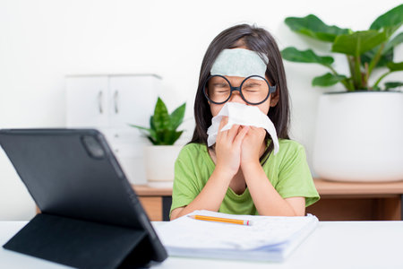 sick little girl, schoolgirl 
uses laptop to study at home. child is bored to learn and gain knowledge remotely. student wants to go to school. digital concept e-learning. Remote.の写真素材