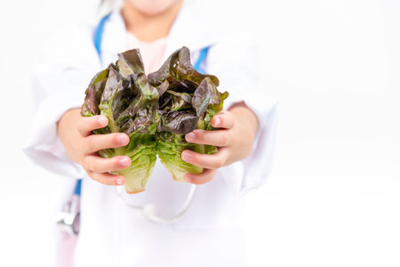 Doctor holding basket assort fresh vegetables isolated on white background.の写真素材