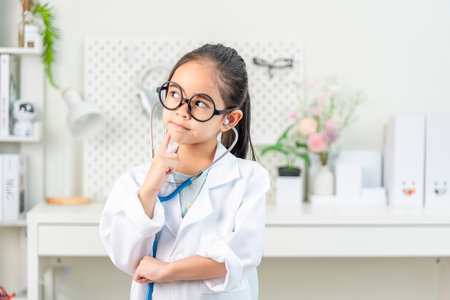 smart doctor Little Girl with white medical coat and stethoscopeの写真素材