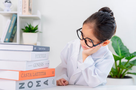 Cute Asia little Girl reading book for researchの写真素材