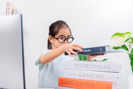 Asia A little girl studying with video online lesson at home.