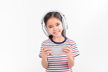 Little girl play phone mobile. Isolated on white backgroundの写真素材