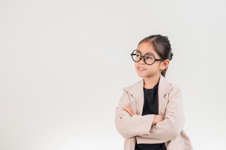 Little business lady Asia. Cute little girl in glasses and formalwear standing on a white background