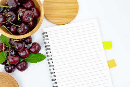 Background Fresh fruit red sweet cherrys isolated in a wooden cup on white backgroundの写真素材