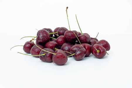 Background Fresh fruit red sweet cherrys isolated on white backgroundの写真素材