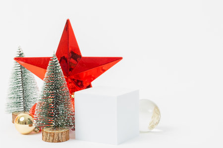 A Christmas tree is surrounded by a star and a white cube. The scene is festive and cheerful, with the star and tree representing the holiday seasonの写真素材