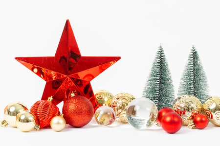 A star is surrounded by many different colored ornaments, including some that are red and goldの写真素材