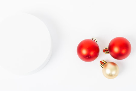 Three red and gold ornaments are on a white background. The red ornaments are placed in a row, with the middle one slightly larger than the other two. The white background provides a cleanの写真素材