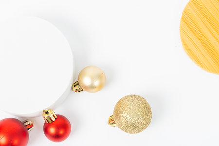 A white background with a red and gold ornament on it. The ornament is a gold ball with a red ball on top of itの写真素材