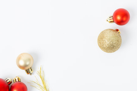A white background with a gold and red ornament. The gold ornament is a ball with glitterの写真素材