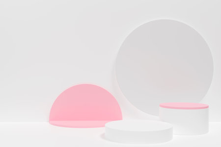 Three white and pink geometric shapes, including a pink circle and two white cylinders. The shapes are arranged in a way that creates a sense of depth and dimensionの写真素材