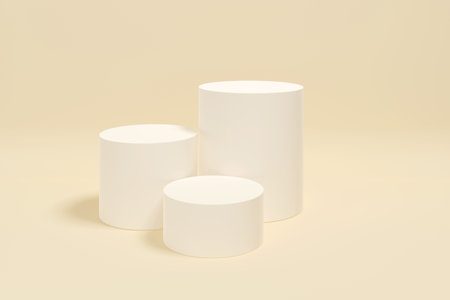 Three white cylinders are arranged in a row on a white background. The cylinders are all the same size and are placed in a straight line. The image has a minimalist and clean lookの写真素材