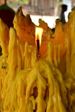 Burned candle and big yellow candle dripping - close upの写真素材