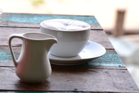 Cup of coffee with artistic cream decorationの写真素材