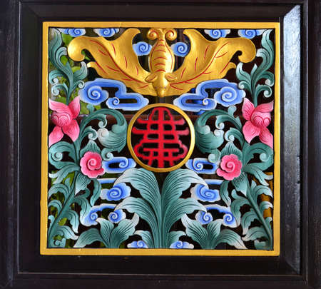 Chinese style wood caving pattern on a wallの写真素材