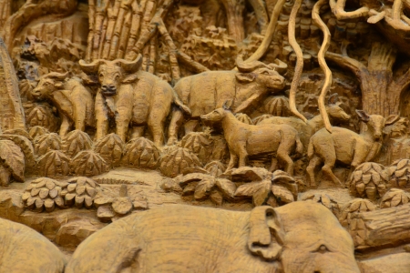 An ancient mural wood carving in Thai temple.の写真素材