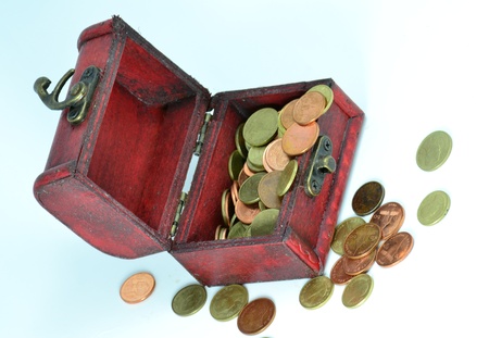 Treasure chest with golden coins isolated on the white background.