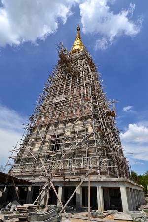 The big pagoda under construction with blue sky background in Thailand.の写真素材