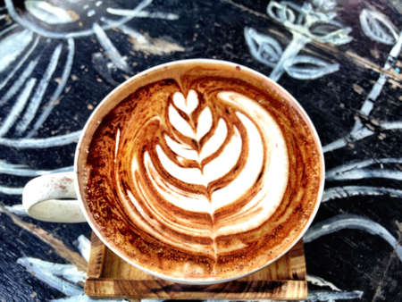 Hot coffee on the wooden desk.