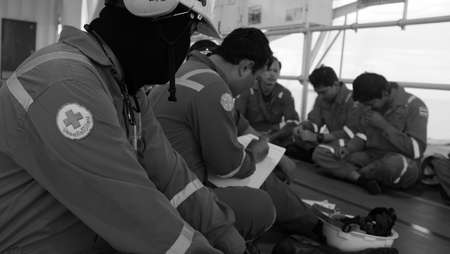 Workers perform a pre job safety analysis.のeditorial素材